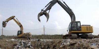 Transferring waste using equipment.
