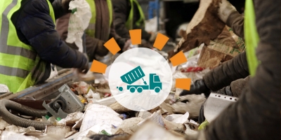 Workers sorting through trash on a conveyor belt. 