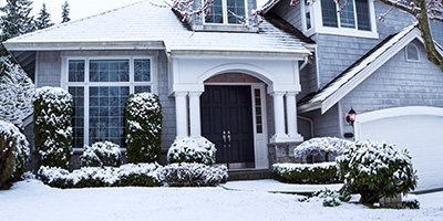 An exterior photo of a snow covered home.