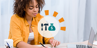 Woman smiling at a desk with a laptop, notebook and calculator as she deducts home project expenses from her tax return.