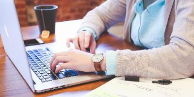 Woman Working on a Laptop at a Shared Office Space