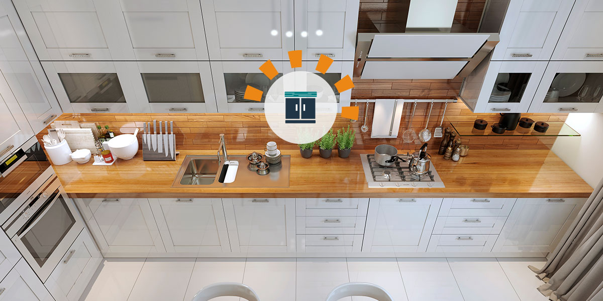 Overhead view of modern kitchen with wood countertops and white cabinets.