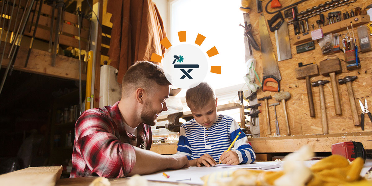 A dad helps his son with a design project at the garage workbench.