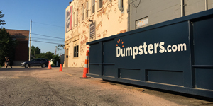 A dumpster delivery space marked with orange cones