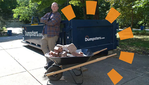 Man With Wheelbarrow of Debris Next to Dumpsters.com Dumpster
