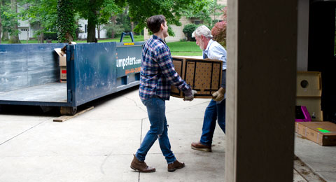 A Blue Roll Off Dumpster Outside of a Home Cleanout Project.