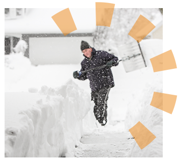 A man in a black hat and coat shoveling snow during a heavy snowstorm. 