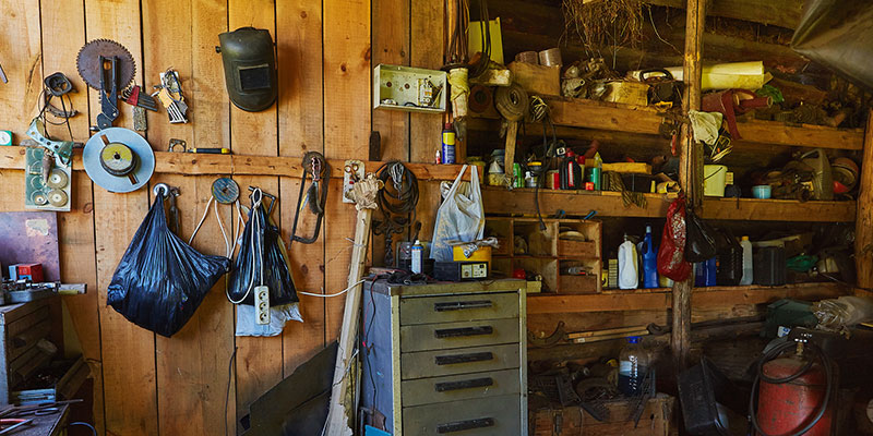 Wooden shed filled with tools and miscellaneous objects.