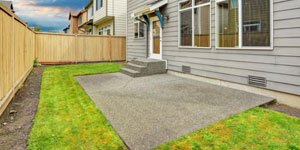 Concrete Patio Surrounded by Grass.