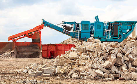 a pile of old concrete at a concrete recycling facility.