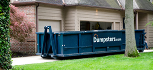 A Roll Off Dumpster in a Driveway.