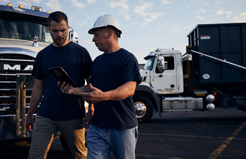 Two Men With Dumpster Truck