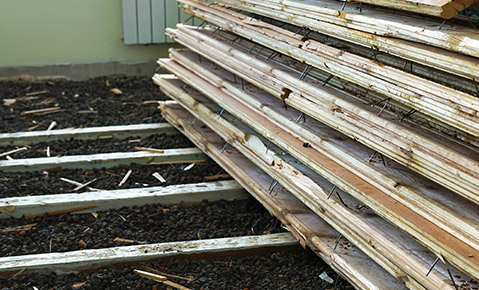 A pile of hardwood flooring waiting for curbside collection.