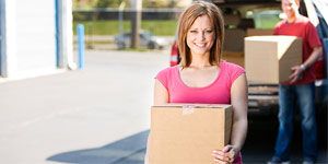 a woman moving boxes