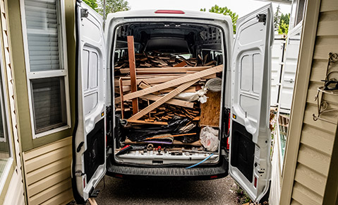 A van being used to haul various junk from a home improvement project.
