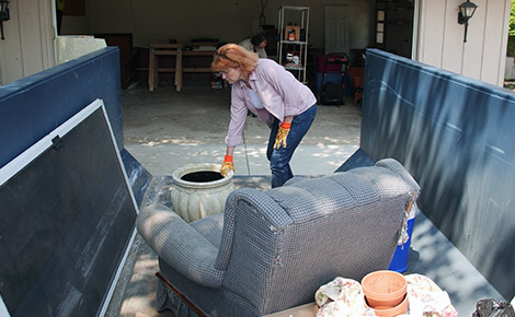 Dumpster Being Used to Dispose of Couch