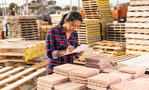 A woman taking inventory of construction materials.