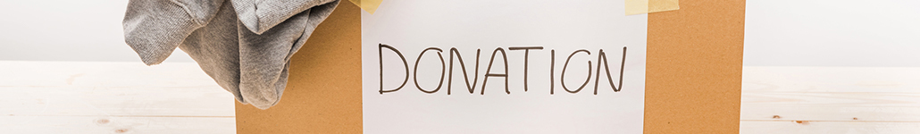 Box Labeled “Donation” Filled with Clothes.