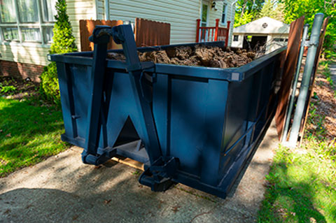 Roll Off Dumpster in Driveway Filled With Dirt