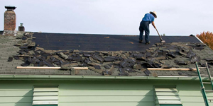 Roofer Scraping Shingles Off the Roof