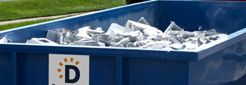 A Roll Off Dumpster Filled with Rubble and Debris.