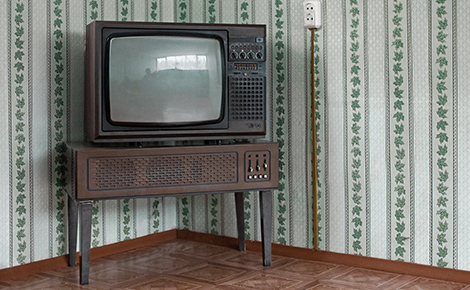 an old tv on a table in a corner