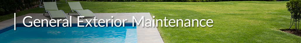 Swimming Pool With Two Lawn Chairs Next to a Green Lawn.