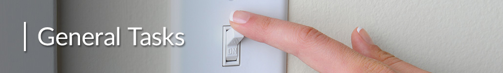 Woman Turning Off a Light Switch