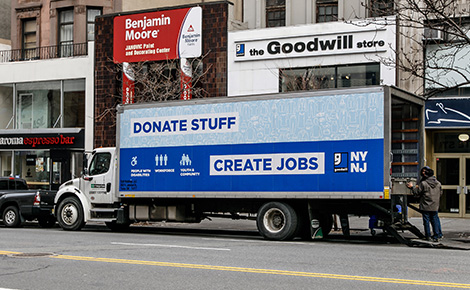 Goodwill truck being unloaded outside of building.
