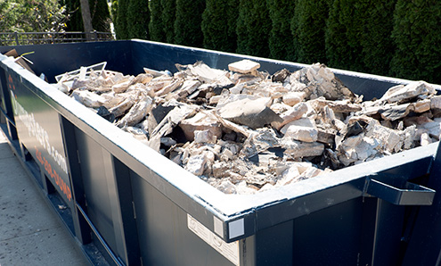 heavy debris inside of 20 yard roll off container