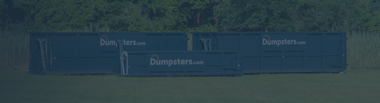 three different sizes of roll off dumpster next to each other in a green field