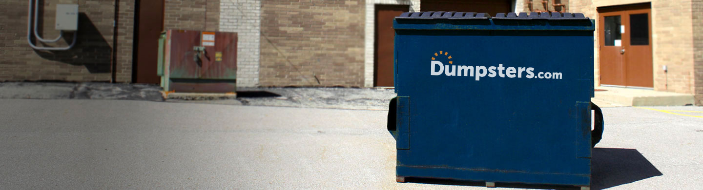 a blue front load bin outside of a corporate building