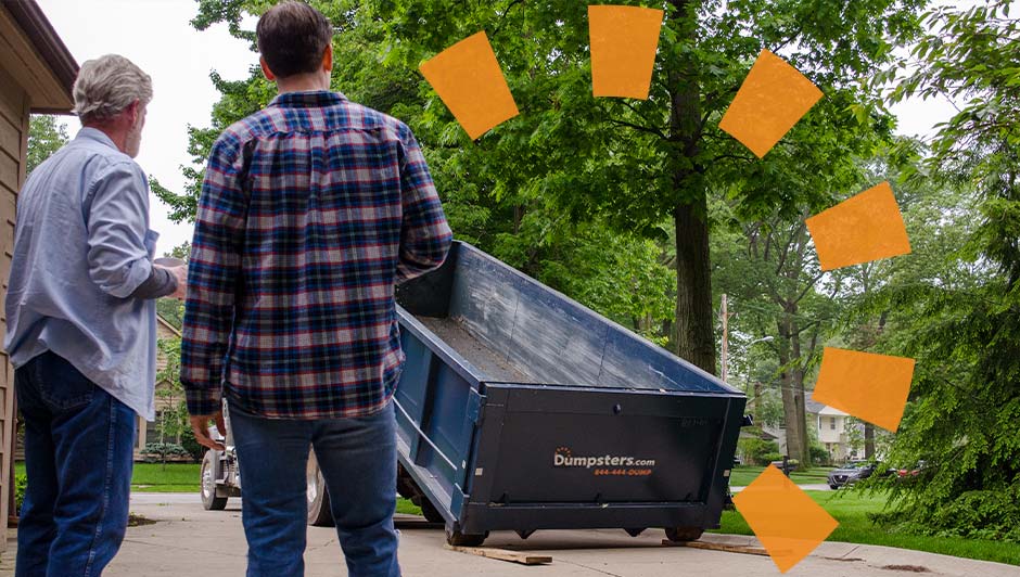 Two Men Looking at a Blue Dumpsters.com Roll Off Dumpster