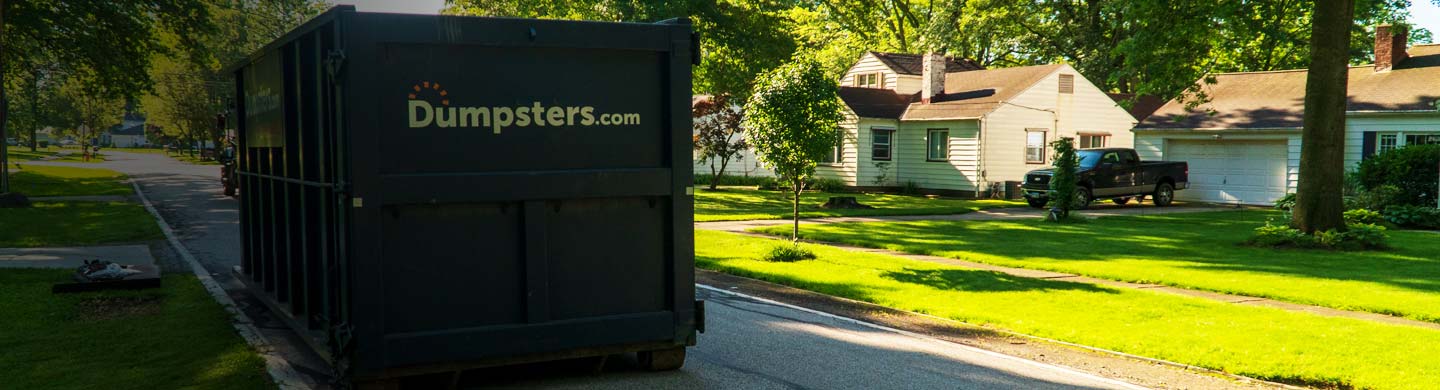 a dumpsters.com roll off dumpster in the street