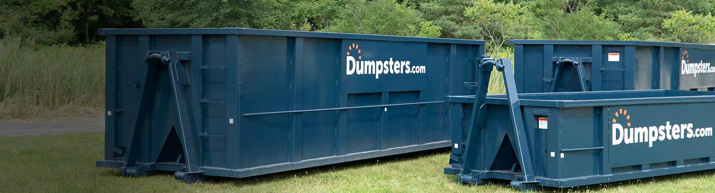 various dumpster sizes in grassy field