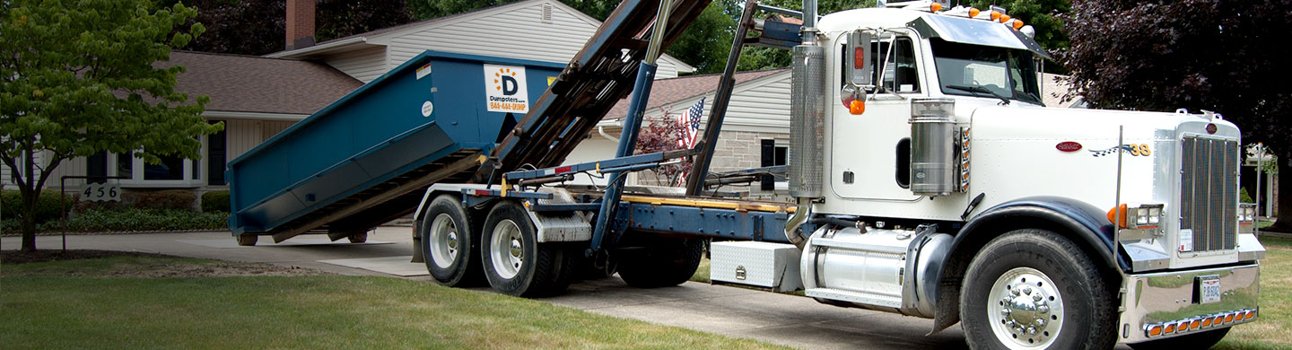 Truck hauling a dumpster