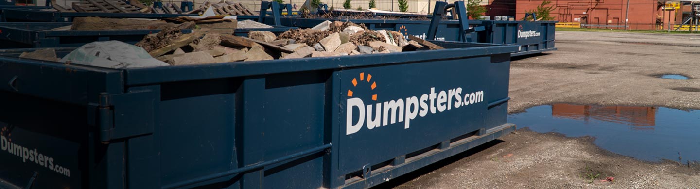 dumpsters.com container full of large slabs of rock