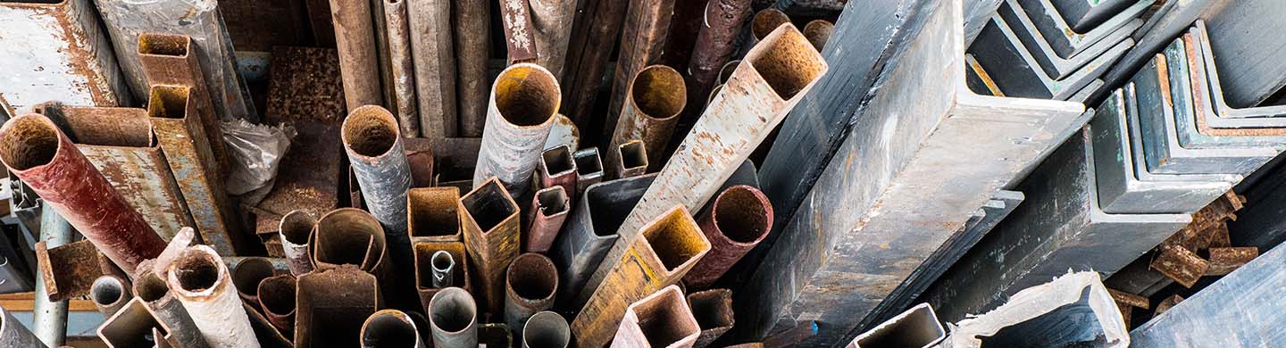 Used metal piping and old scrap metal organized by type.