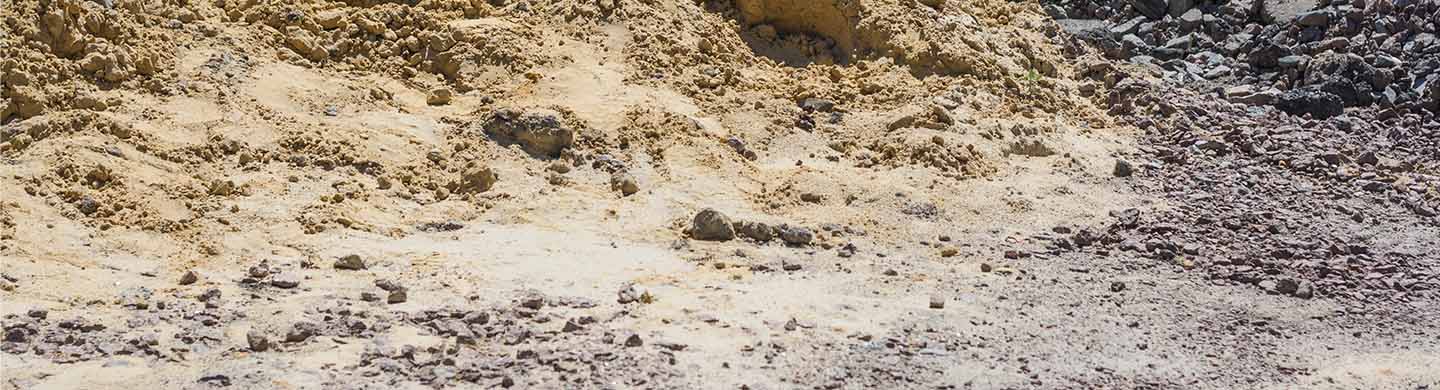 Two piles of dirt sitting on the ground.