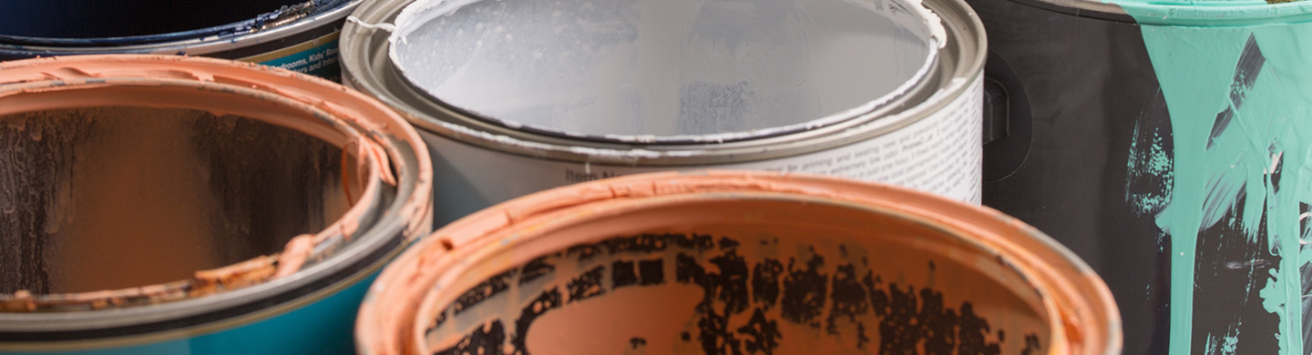 Close up of multicolored paint cans.