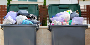 Two Overflowing Trash Cans