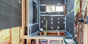 A bathroom stripped to the studs.