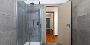 A Shower With Glass Doors and Tile Walls.