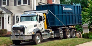 A Blue Dumspters.com Roll Off Dumpster on a Truck.