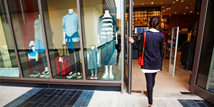 A Woman Stands Outside of a Retail Store