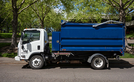 Junk removal service truck parked on the street.