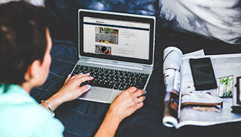 woman looking at a laptop screen