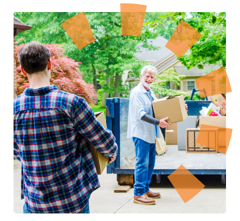 Two men loading a roll off dumpster with boxes during a home cleanout.