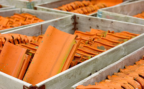 Wooden crates full of orange old tile to be recycled.