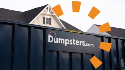 Close up image of blue dumpster in front of house with Dumpsters.com logo.